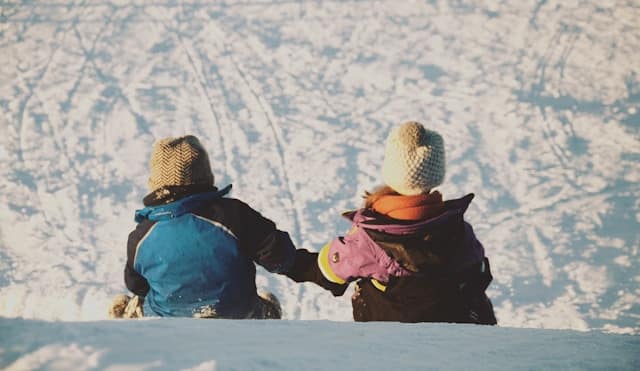 Kids in snow sledging